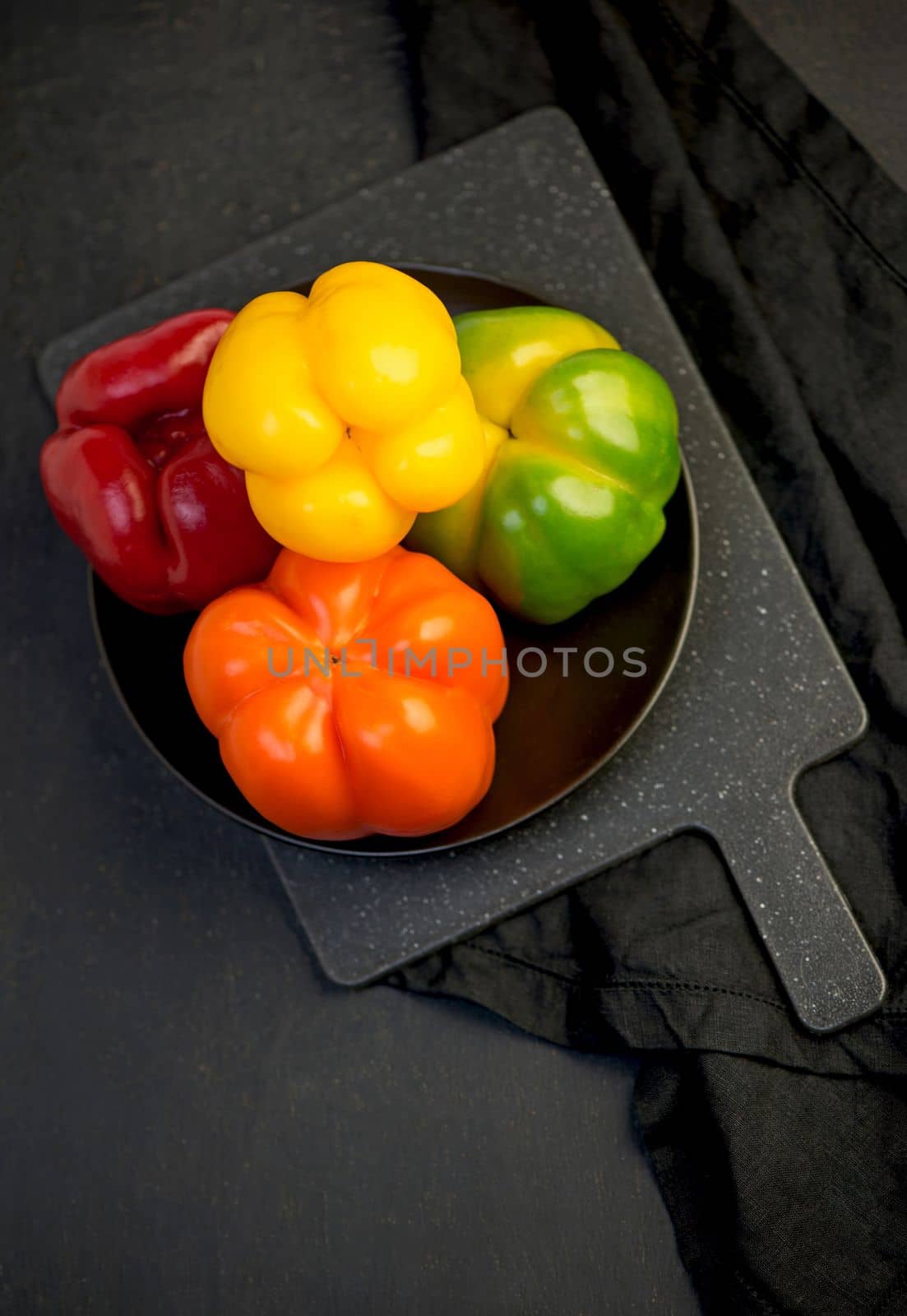 sweet pepper, red, green, yellow pepper on black background, full depth of field by aprilphoto