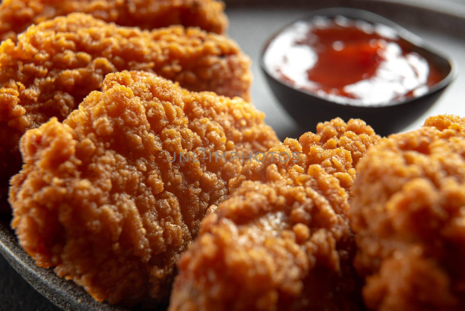 Fried chicken fillet on a dark background. Fried chicken wings as in KFC at home close-up