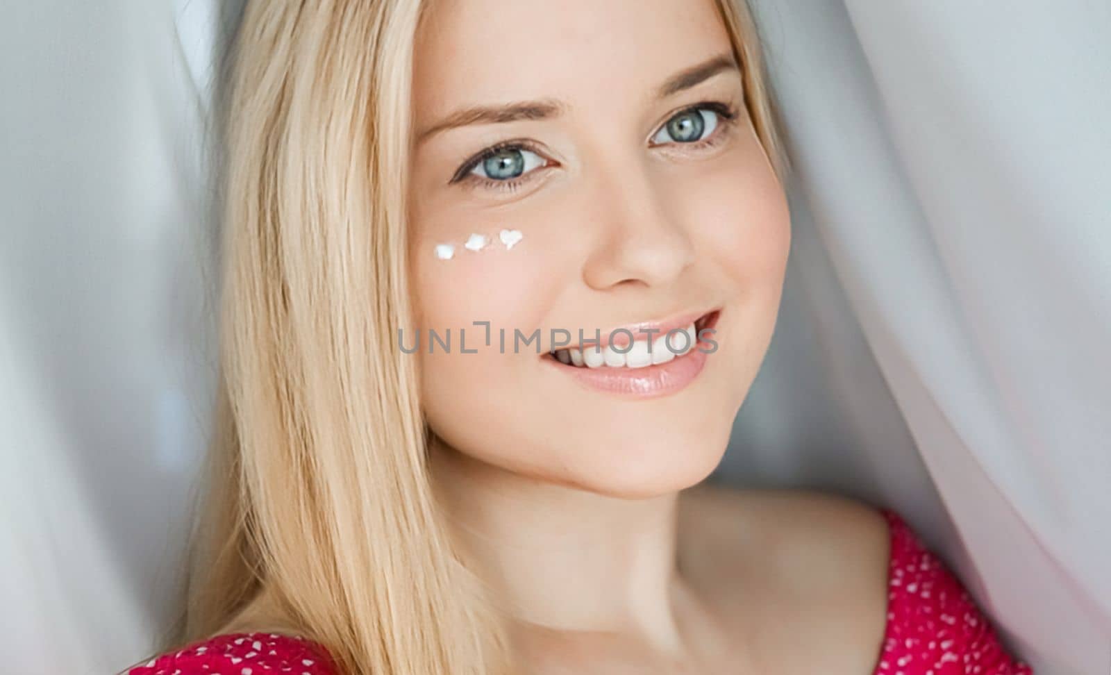 Beautiful woman with skincare cream on her face by Anneleven