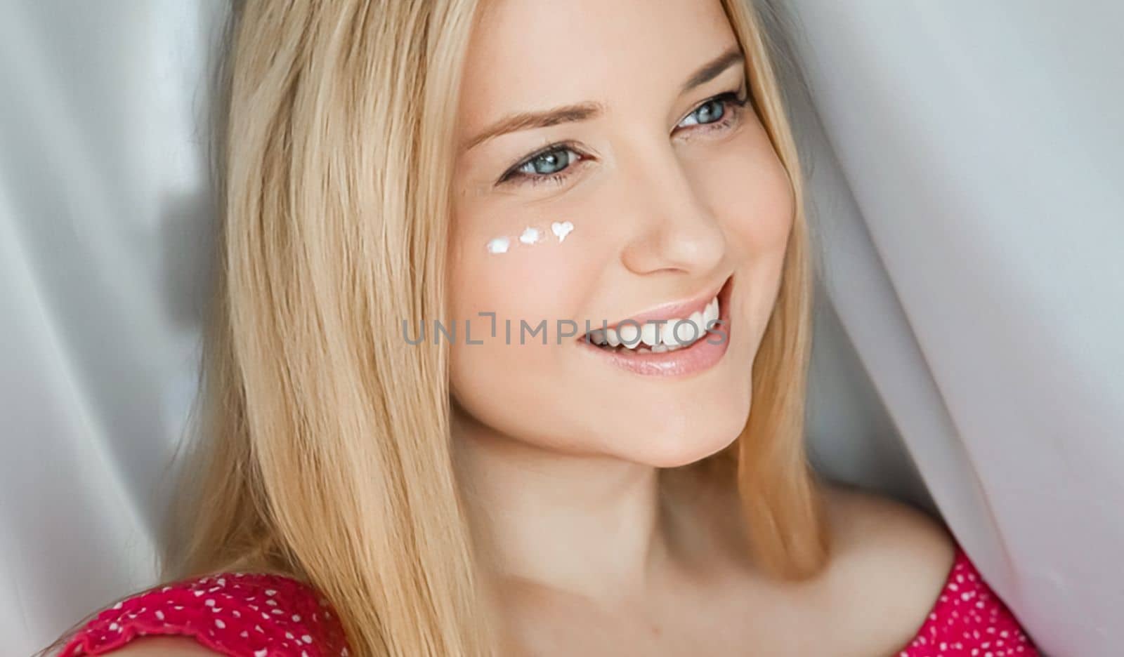 Beautiful woman with skincare cream on her face by Anneleven