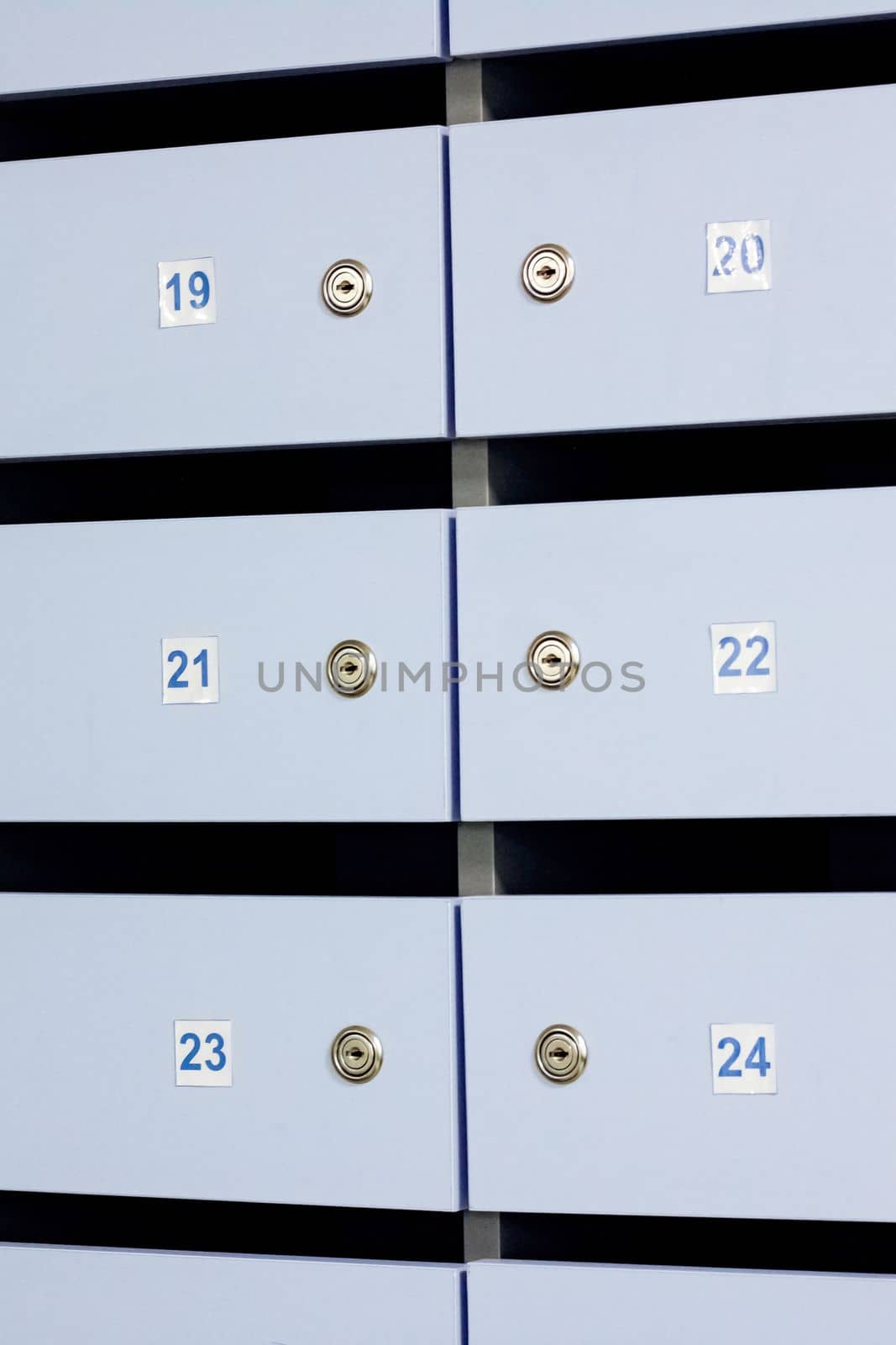 Blue mailbox doors with numbers close up, background