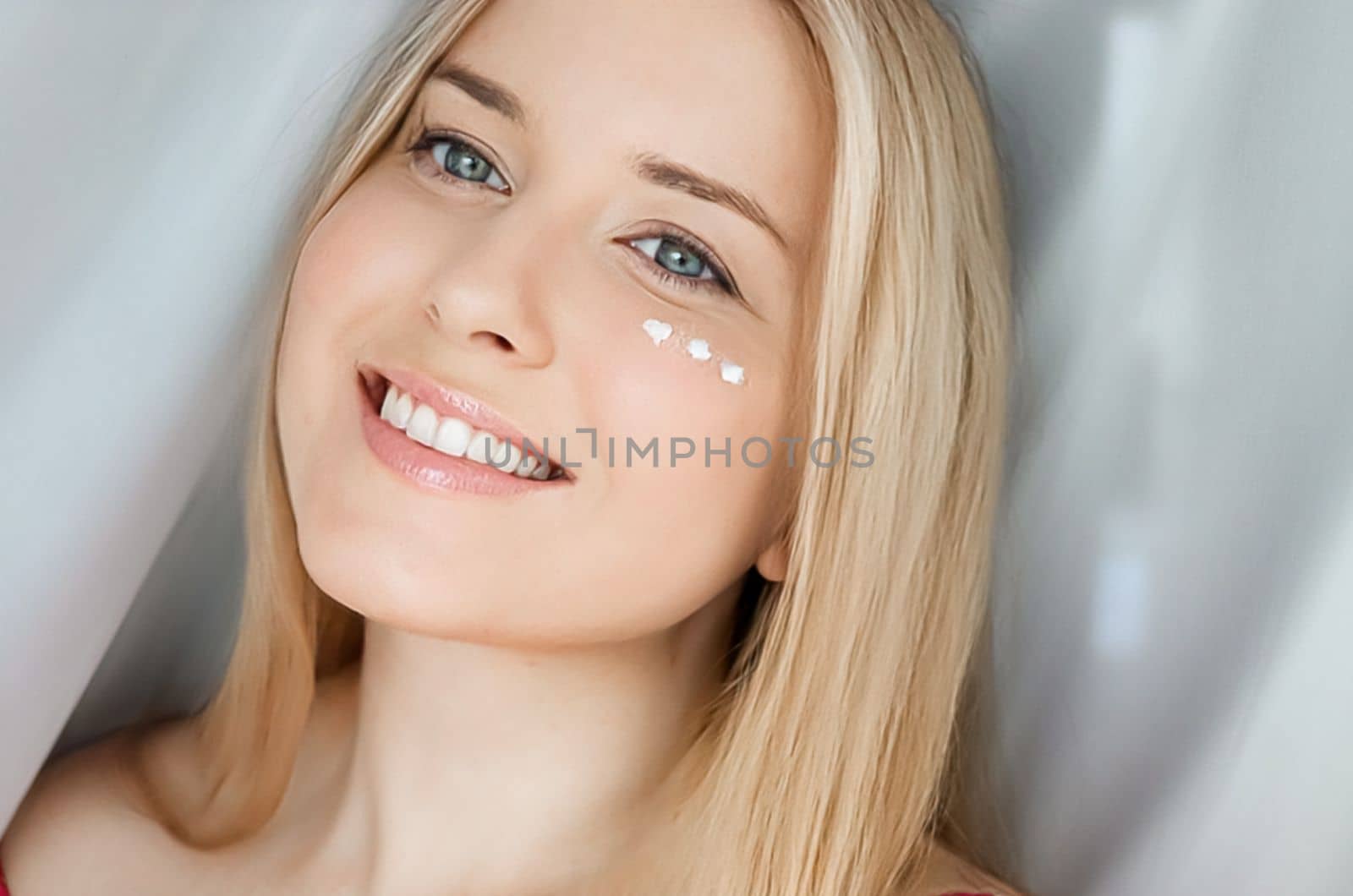 Beautiful woman with skincare cream on her face by Anneleven