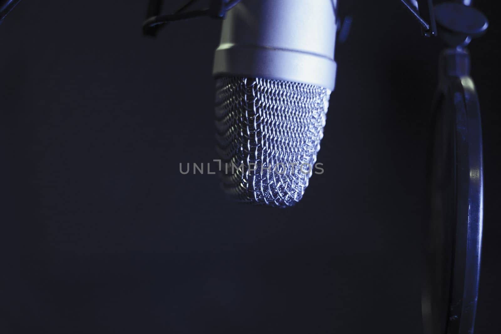 Professional microphone suspended in the air of professional studio