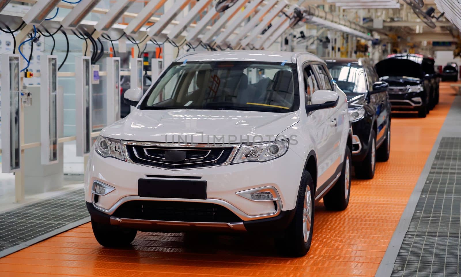 Factory for the production of cars, factory conveyor. Cars are being assembled.