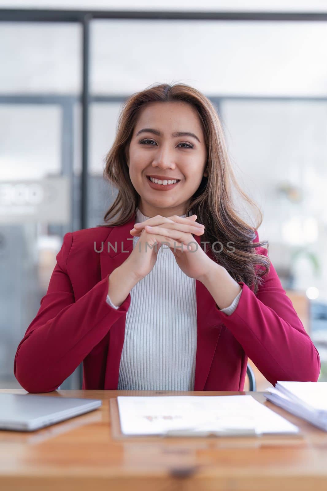 Portrait of Smiling asian business woman with laptop computer in office. Woman in suit at office by itchaznong