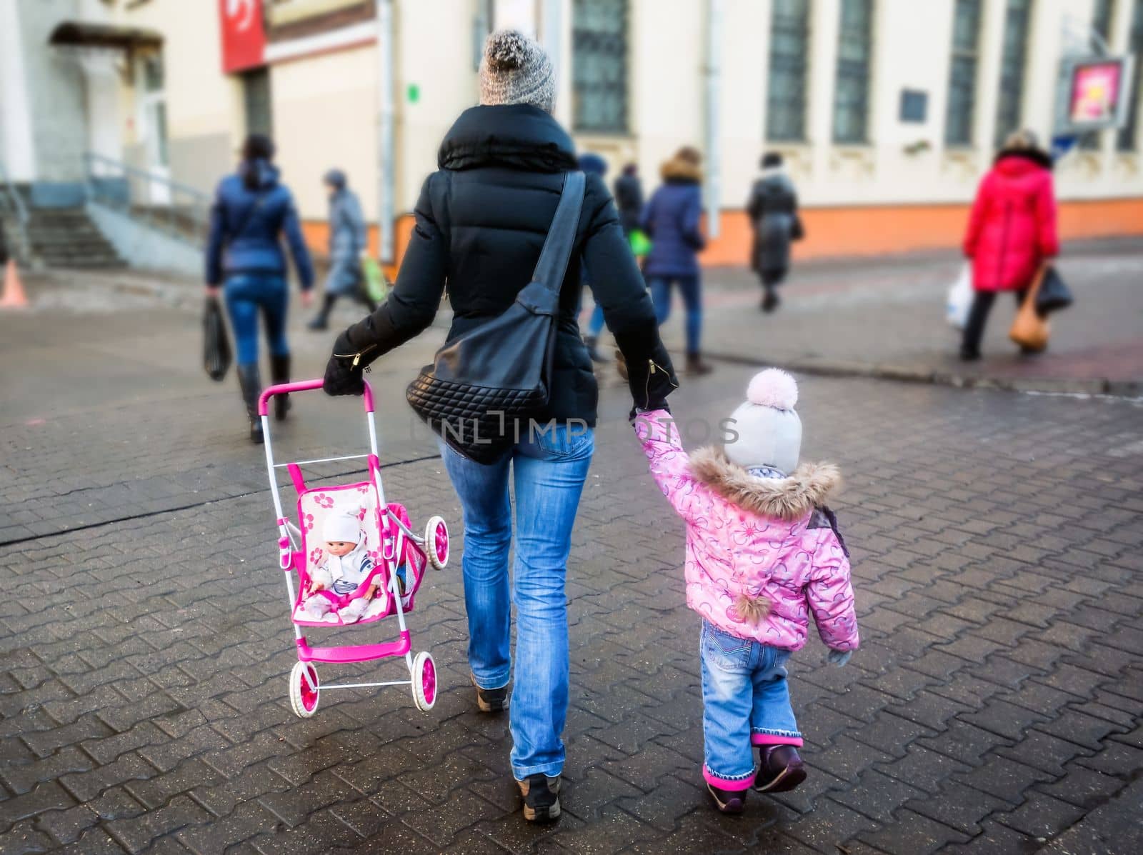 sale, consumerism and people concept - happy mother and child with shopping bags walking along city street