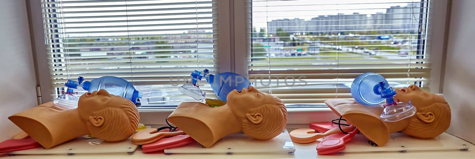 CPR first aid resuscitation adult man life size training dummy model, doll face closeup, detail, mannequin mouth wide open, medical equipment. Paramedic class training simple props abstract concept