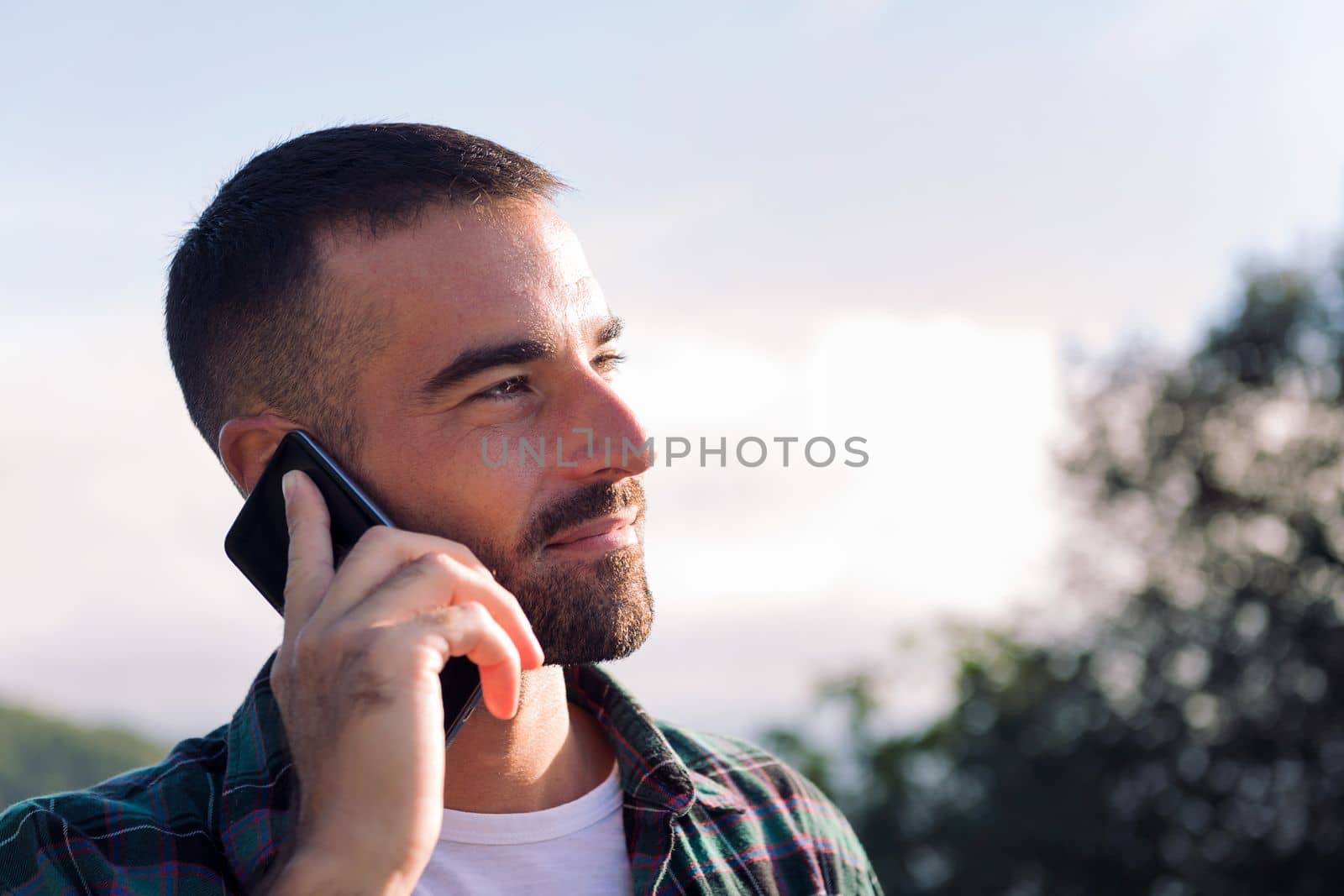 young man talking on mobile phone, concept of freedom and technology, copy space for text