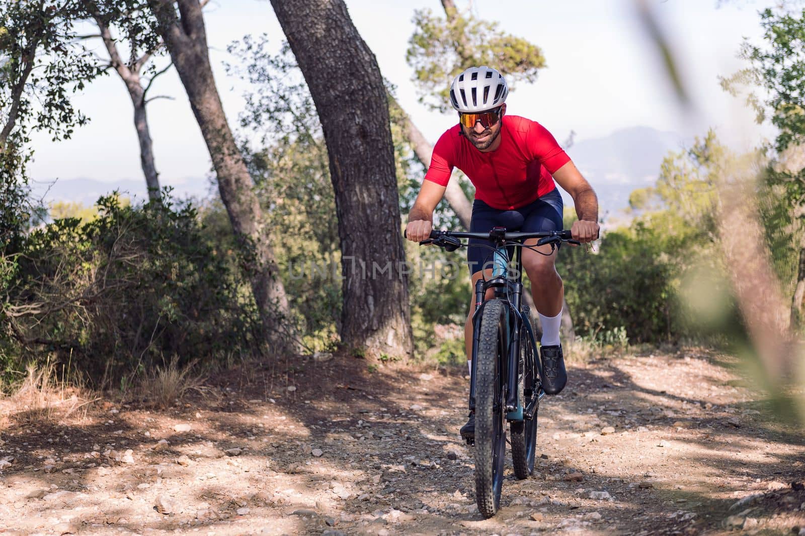 young cyclist training in the bush with his mountain bike, concept of freedom and sport in nature, copy space for text