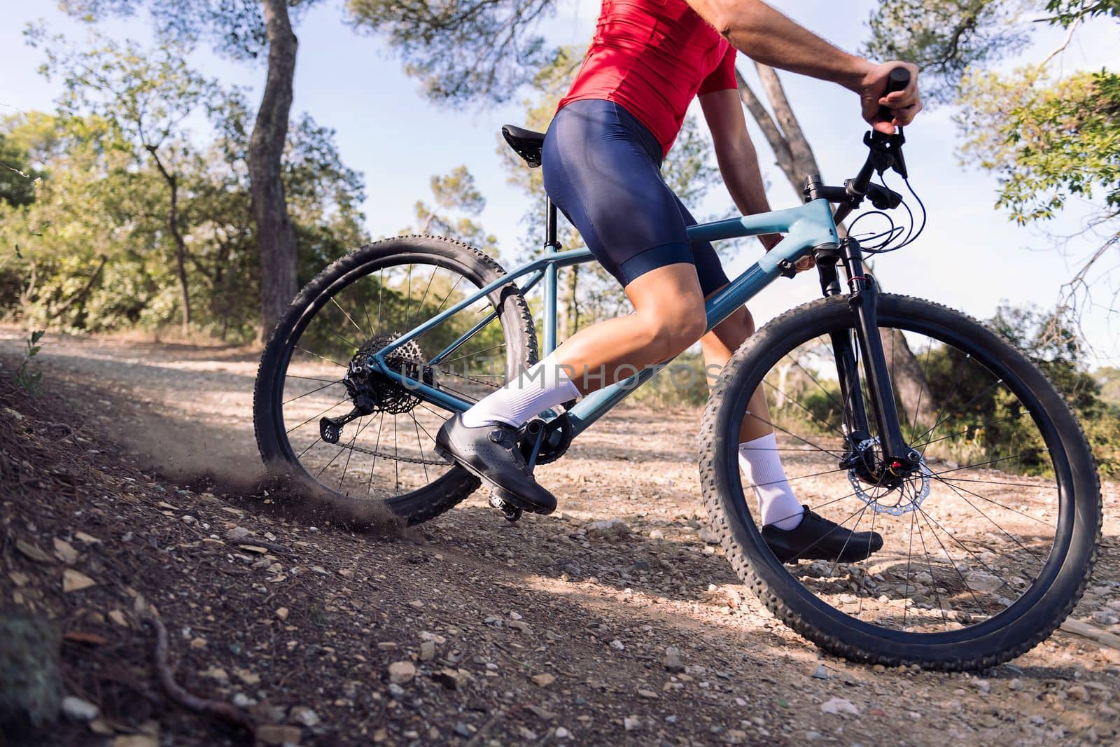 legs of an unrecognizable cyclist drifting on his mountain bike, concept of freedom and sport in nature
