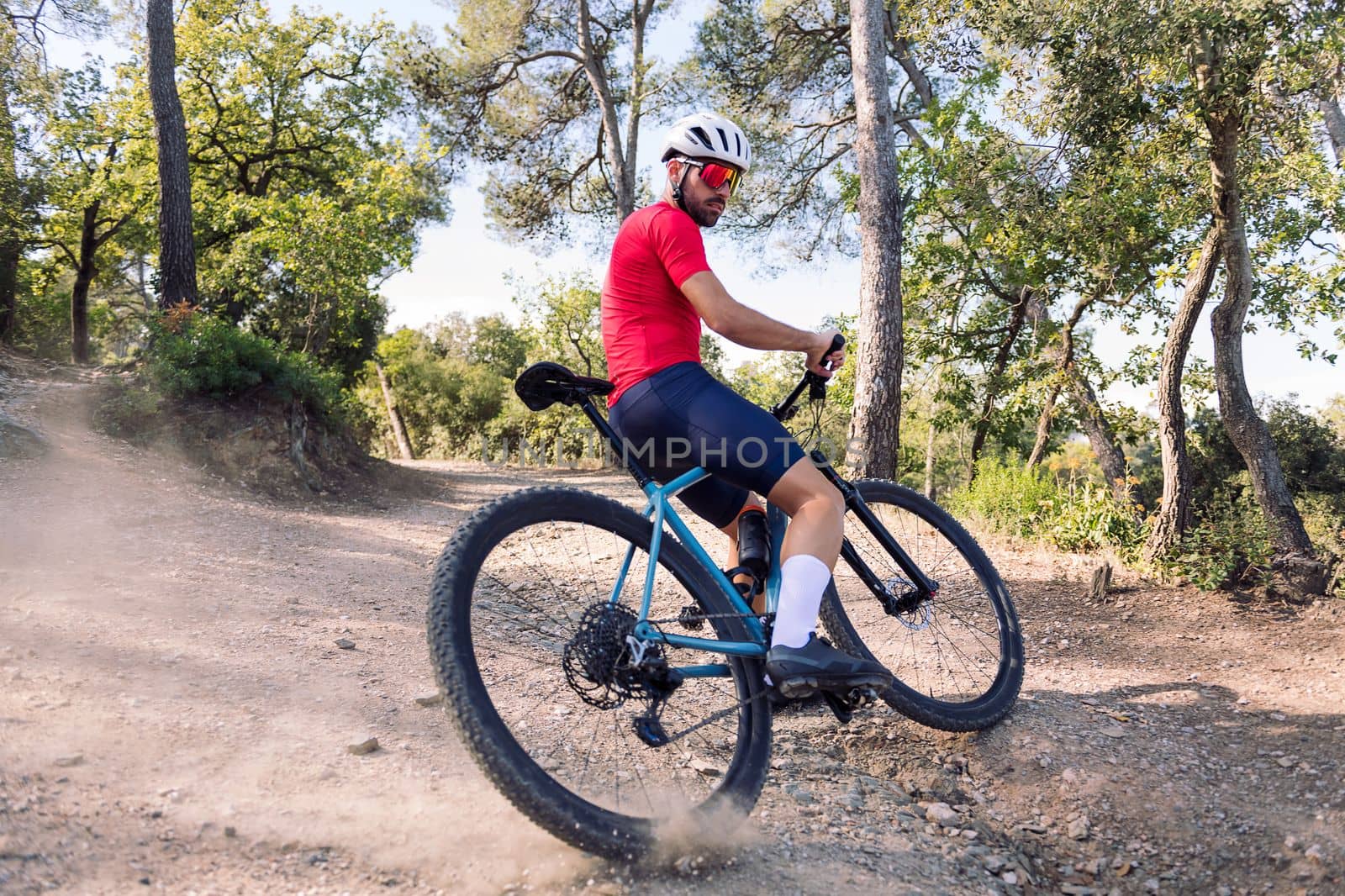 young cyclist drifting with his mountain bike, concept of freedom and sport in nature