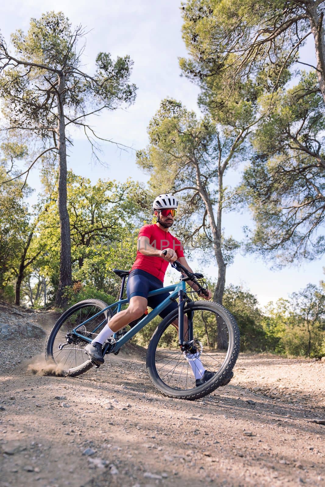 young cyclist drifting with his mountain bike, concept of freedom and sport in nature, copy space for text