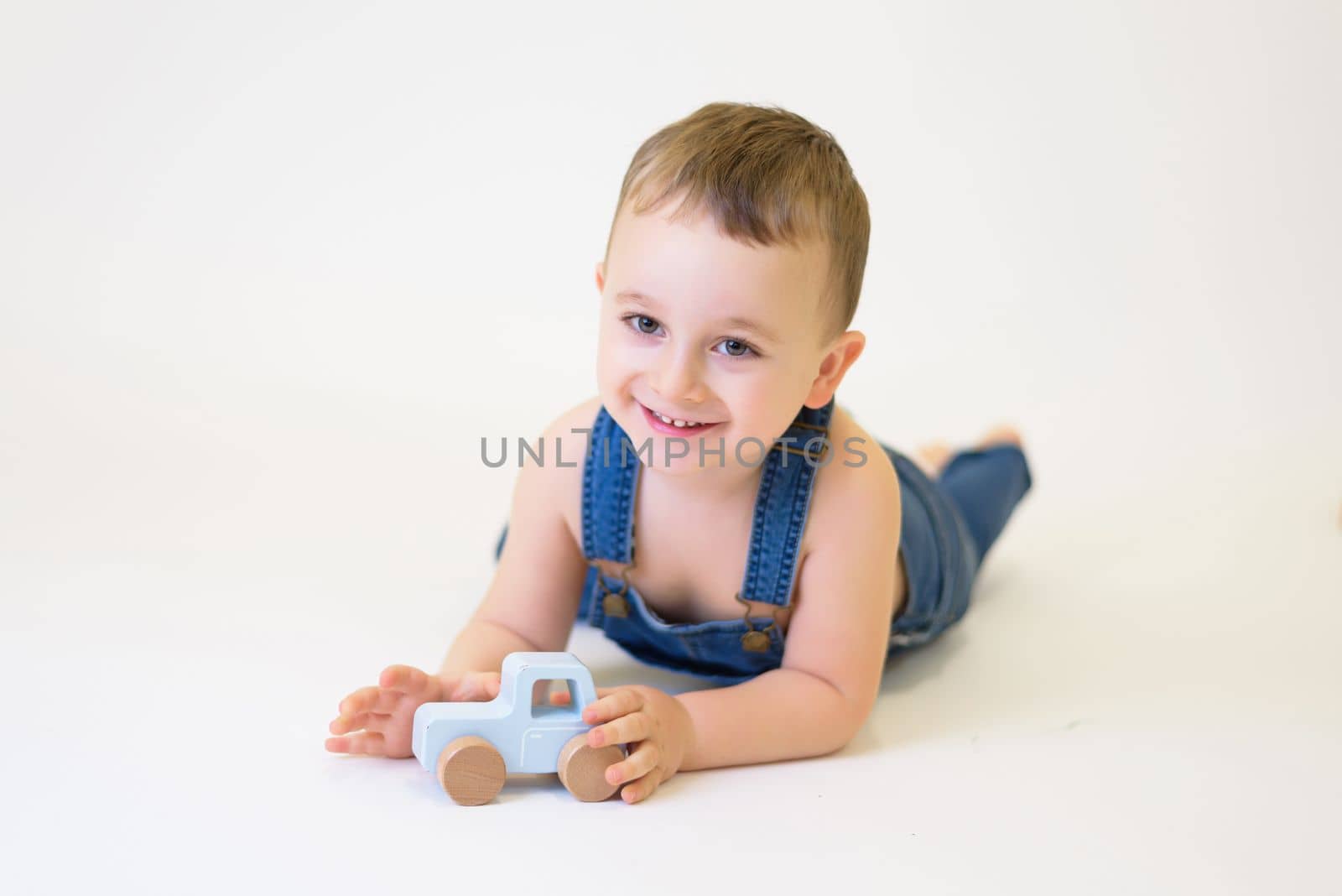 child playing with toys on white background.