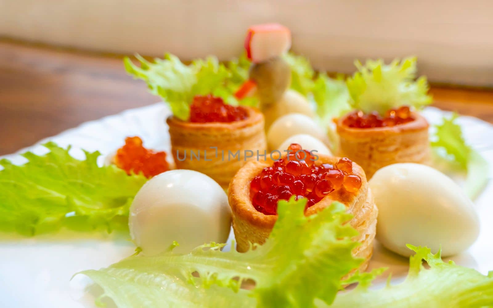 Closeup of caviar and cream cheese appetizer on crackers by kajasja