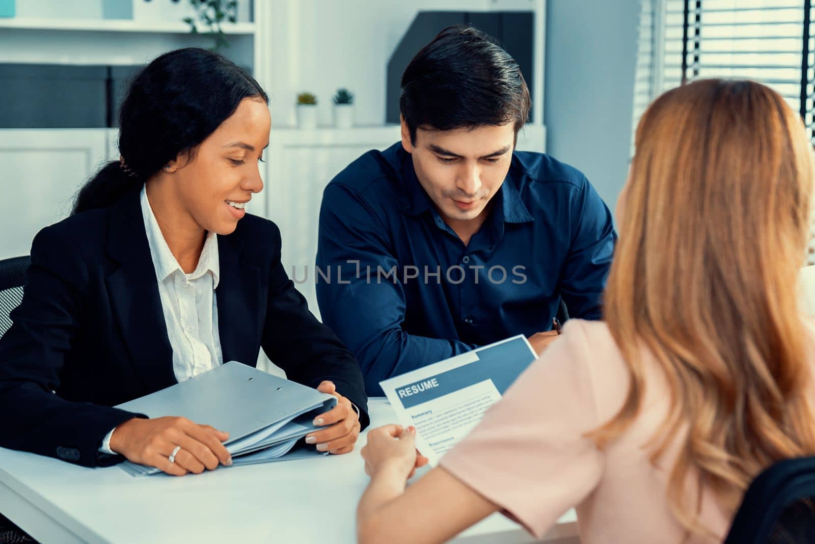A young female asian candidate tries to impress her interviewer by being competent. International company, multicultural environment in workplace.