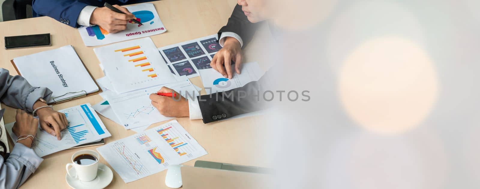 Smart businessman and businesswoman talking discussion in widen group meeting at office table in a modern office interior. Business collaboration strategic planning and brainstorming of coworkers.