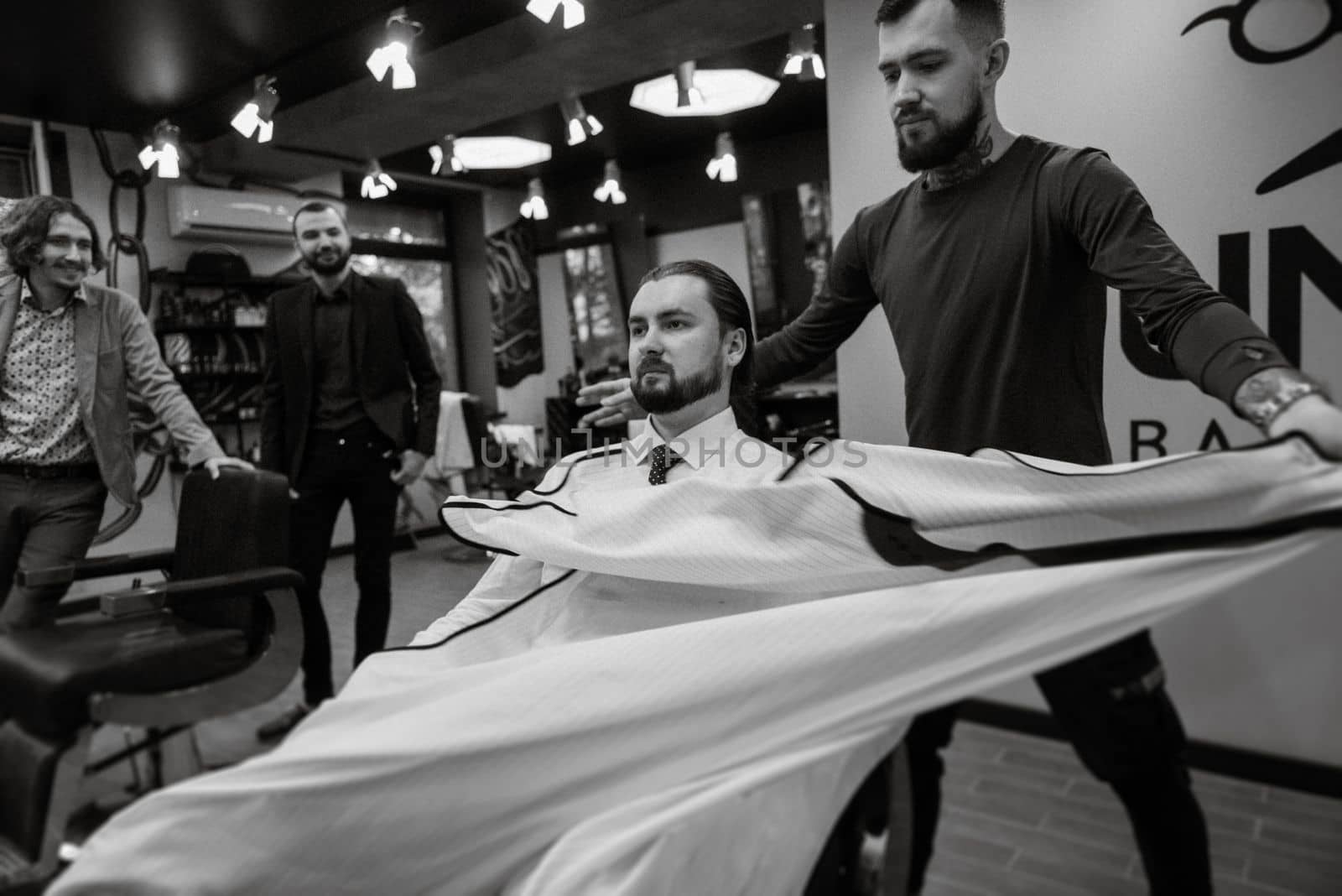 bearded man cutting his beard in the barbershop by Andreua