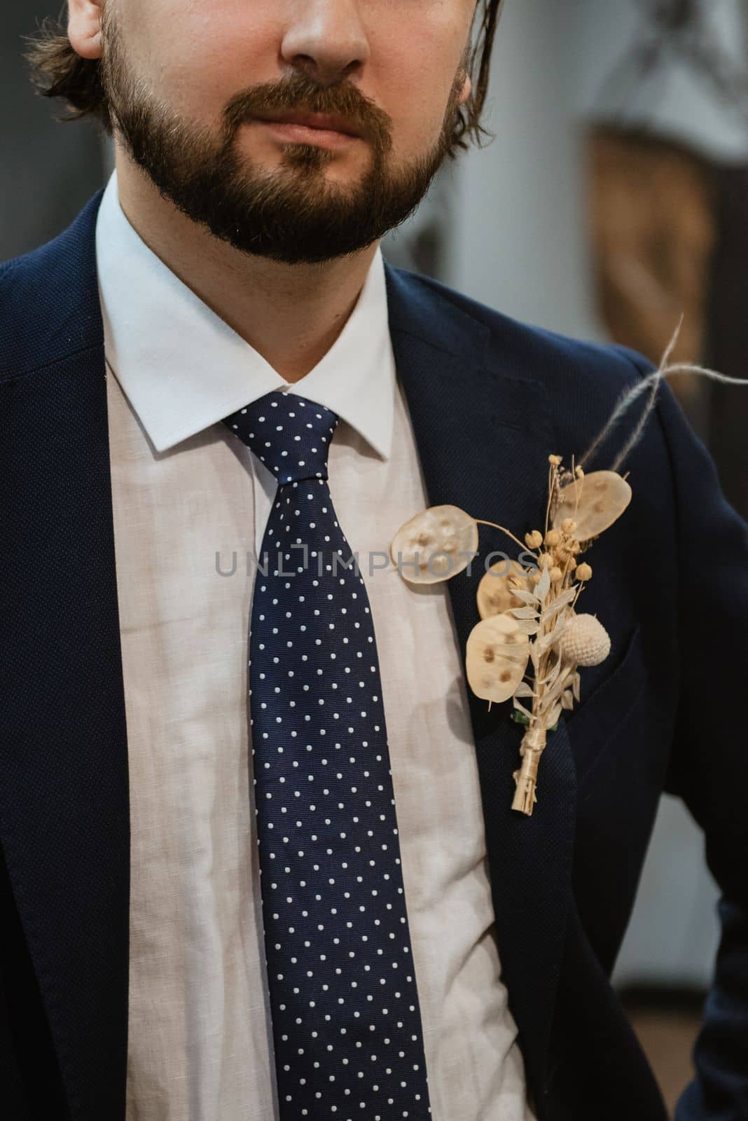 portrait of a male groom in a blue suit in the morning going to the barbershop on the wedding day