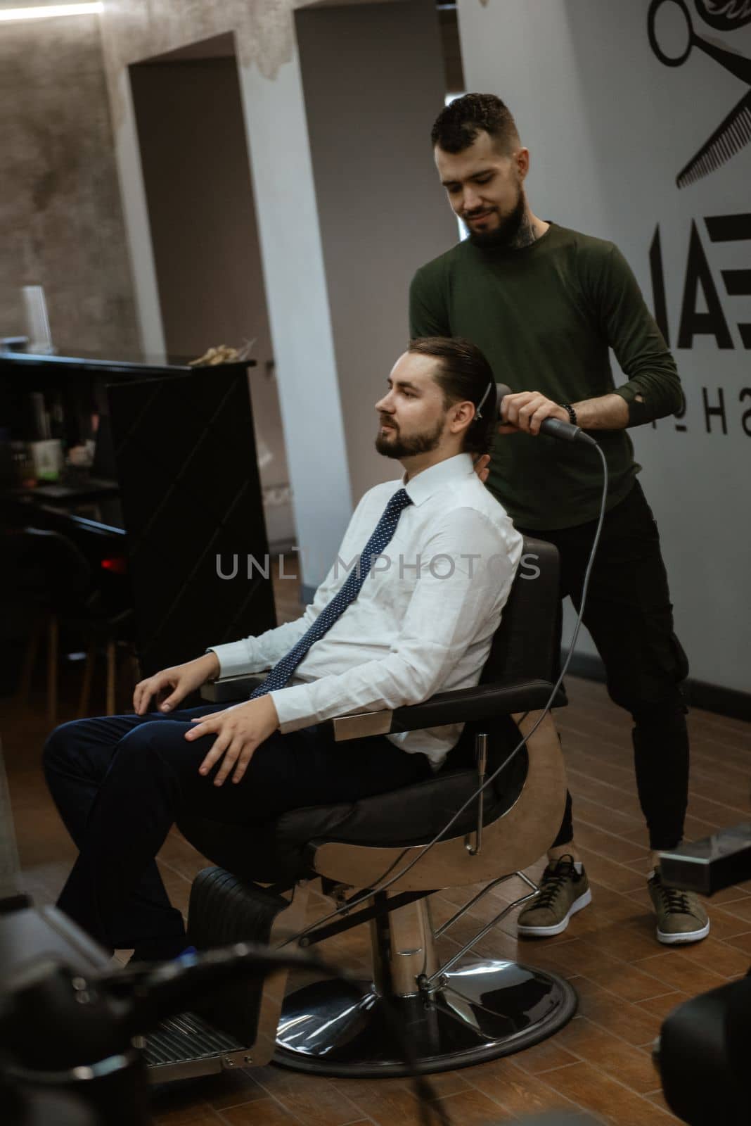 bearded man cutting his beard in the barbershop by Andreua