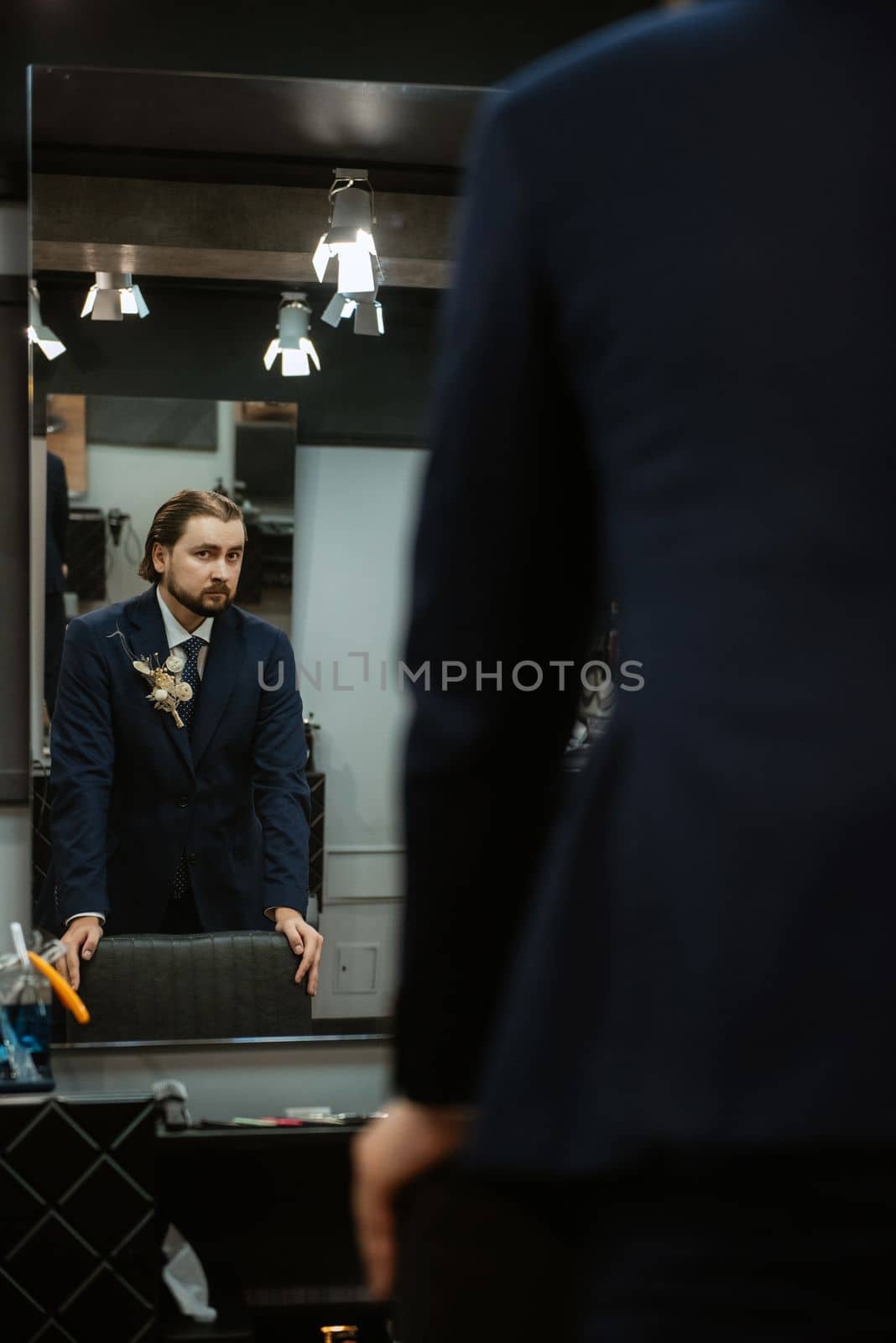 portrait of a male groom in a blue suit in the morning  barbershop by Andreua