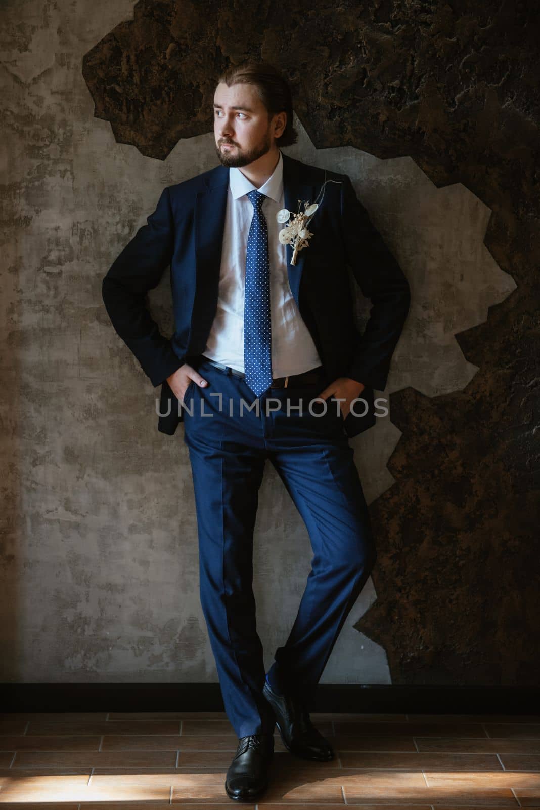 portrait of a male groom in a blue suit in the morning  barbershop by Andreua