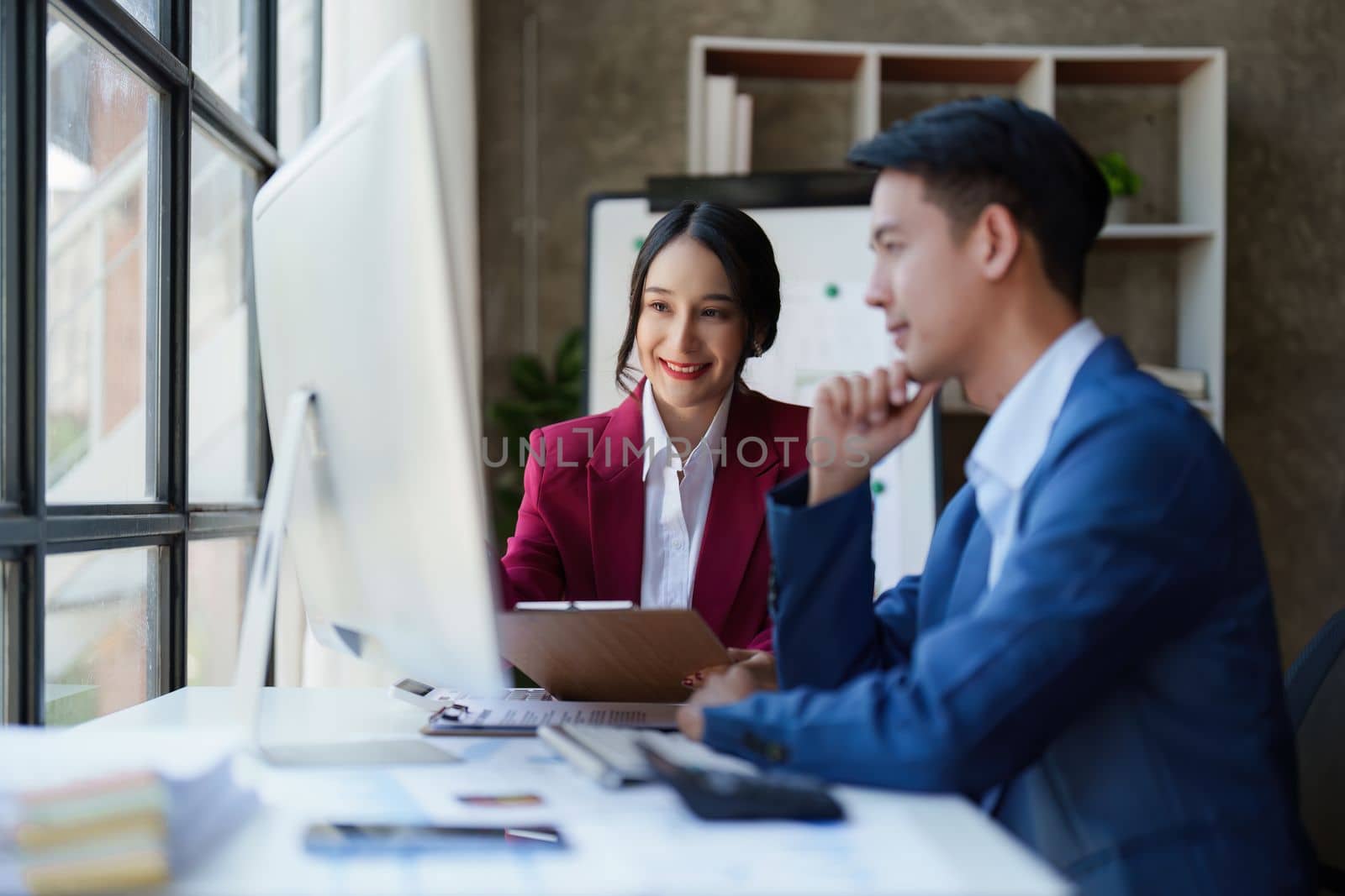 Beautiful business woman consultant talking with asian business person at meeting room with new financial market. Accounting concept by itchaznong