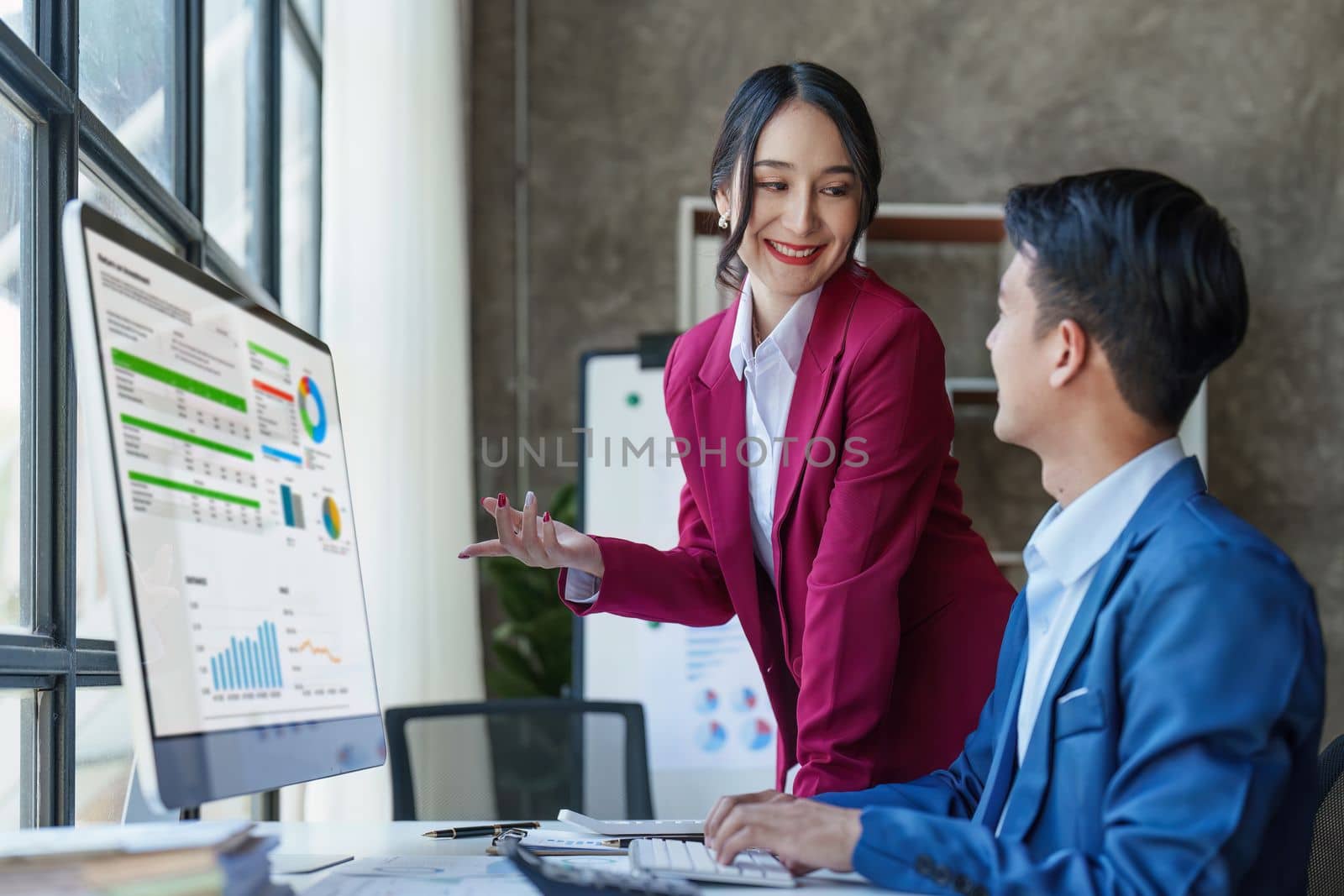 Beautiful business woman consultant talking with asian business person at meeting room with new financial market. Accounting concept by itchaznong