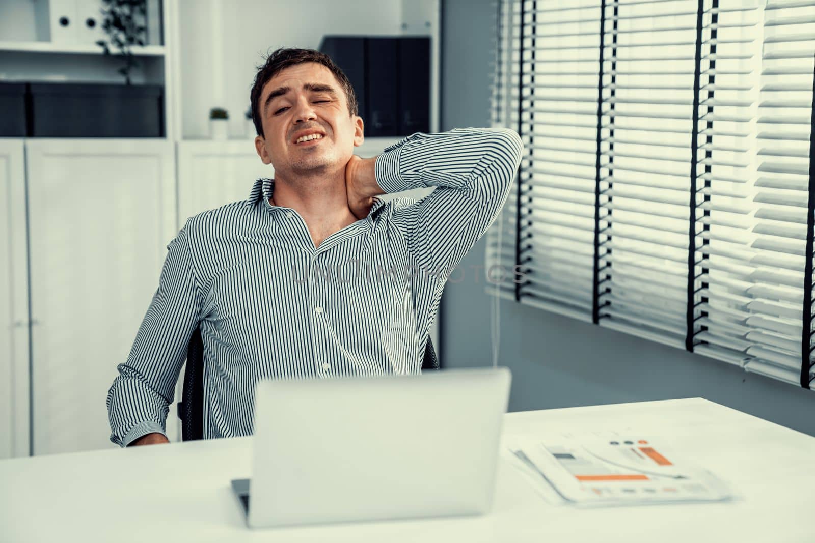 Competent office worker experiencing fatigue and neck pain. Unhealthy concept for office workers, office syndrome.