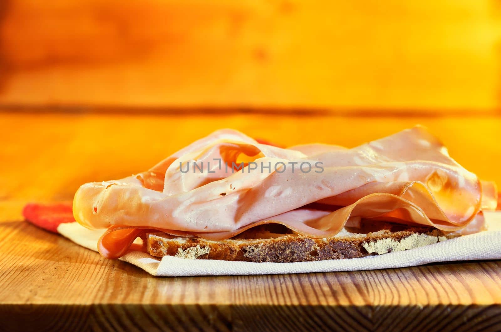 Appetizing mortadella sandwich , fresh slice of bread on  napkin with ham ,