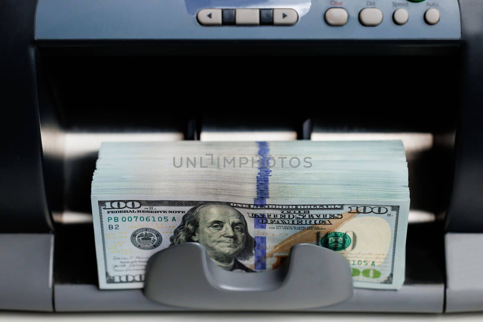 Machine counting money. Cash counting machine calculating 100 dollar bills. Closeup of bank automatic equipment for counting cash money. Currency exchange of one hundred dollar banknotes by uflypro