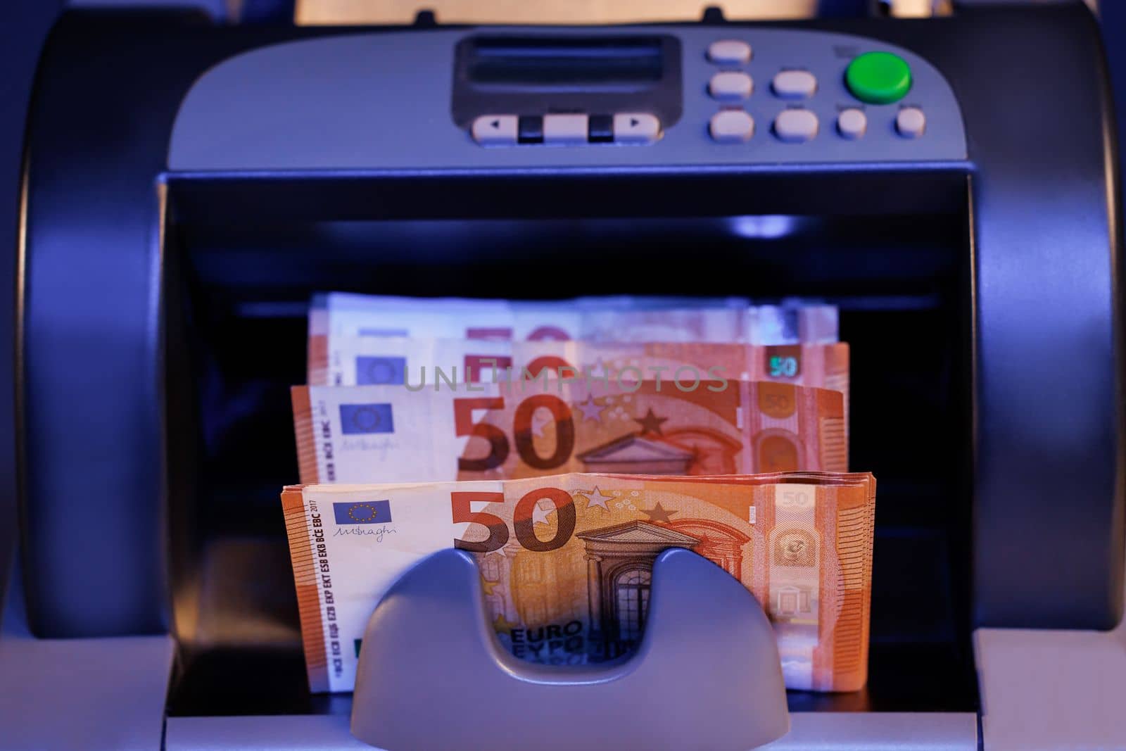 Counting mechanism is processing euros. 50 euro banknotes counting in the machine. Euro currency on counting machine.
