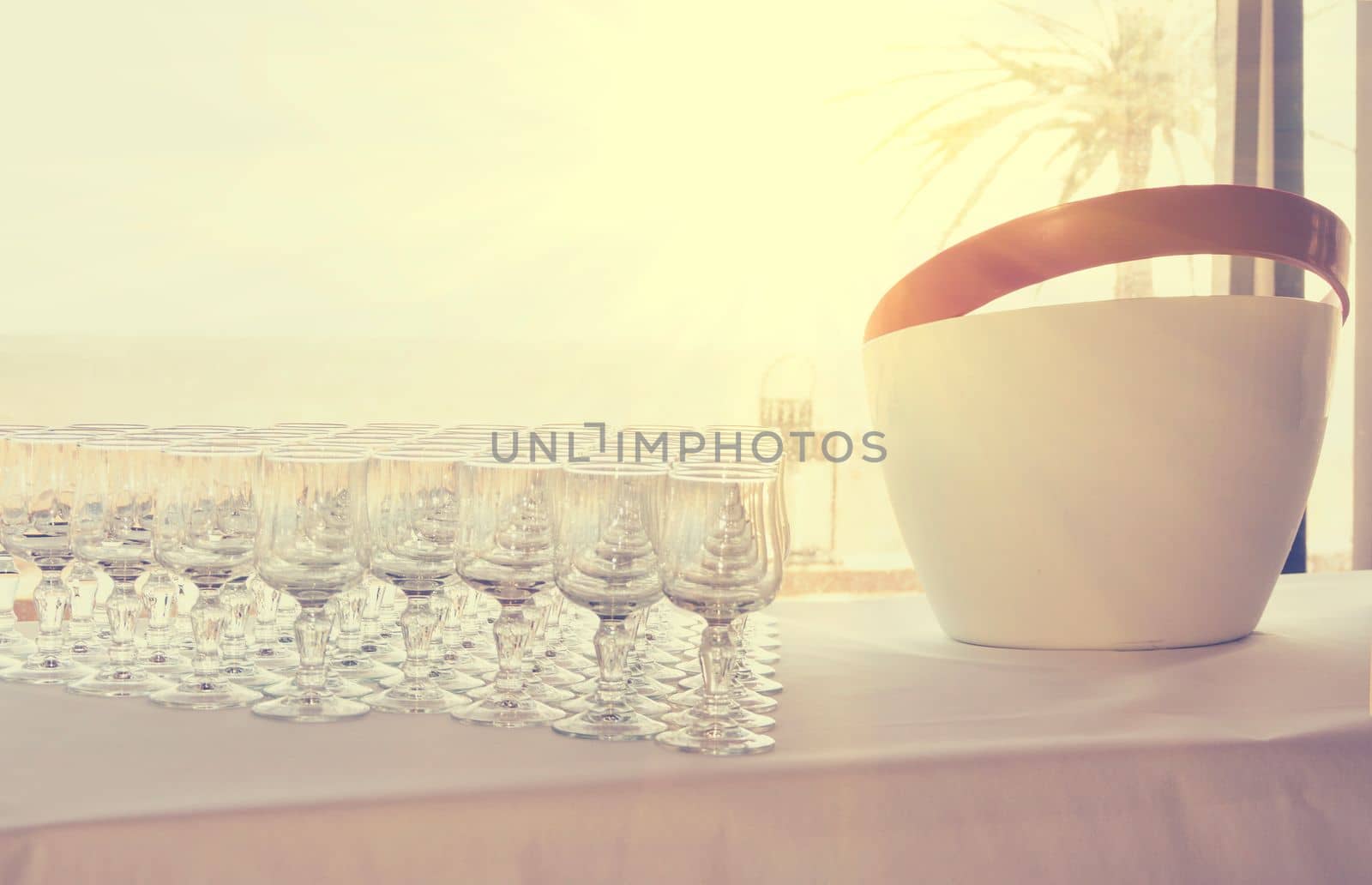 a row of empty glasses on a table at a wedding for laxative drinks Buffet