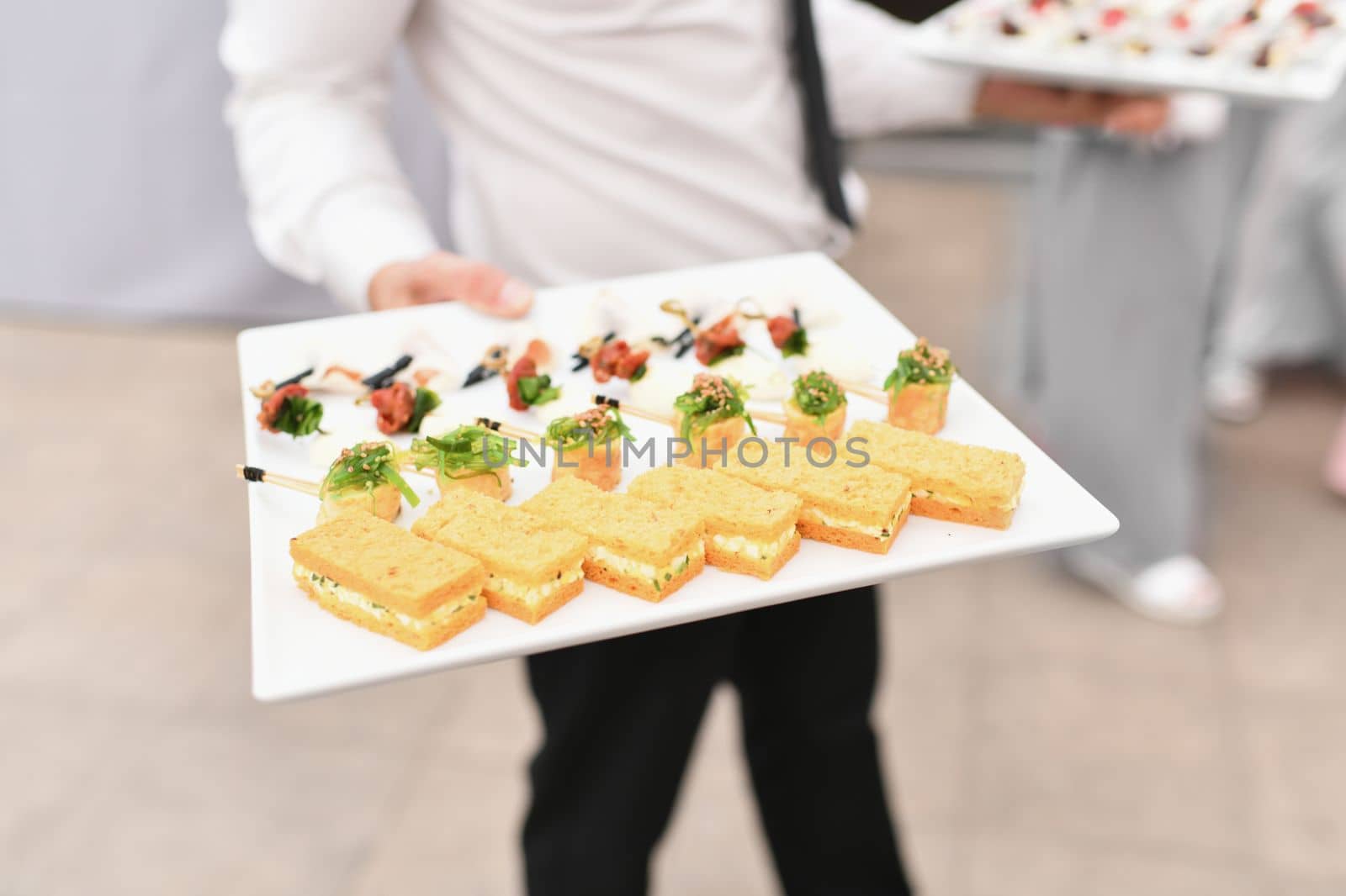 Waiter serving small appetizers at a wedding