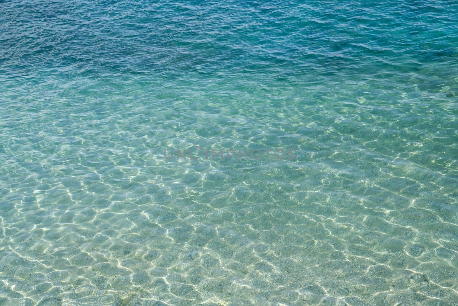 Seawater surface, sun's rays shimmer on water surface by Laguna781