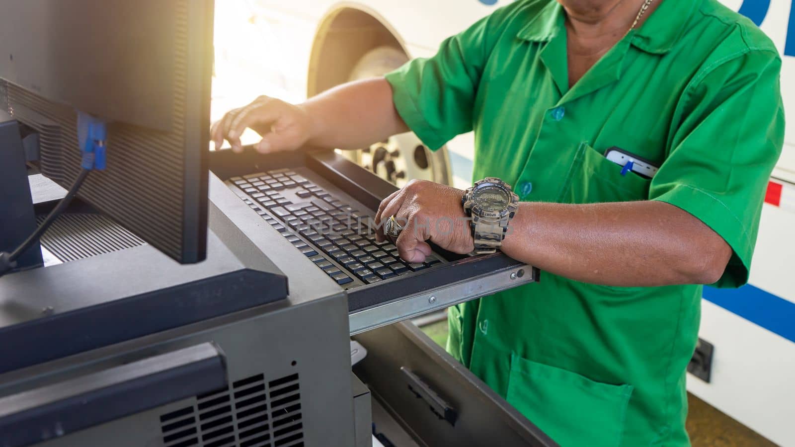 Unrecognizable Latino man performs bus mechanics in the computer