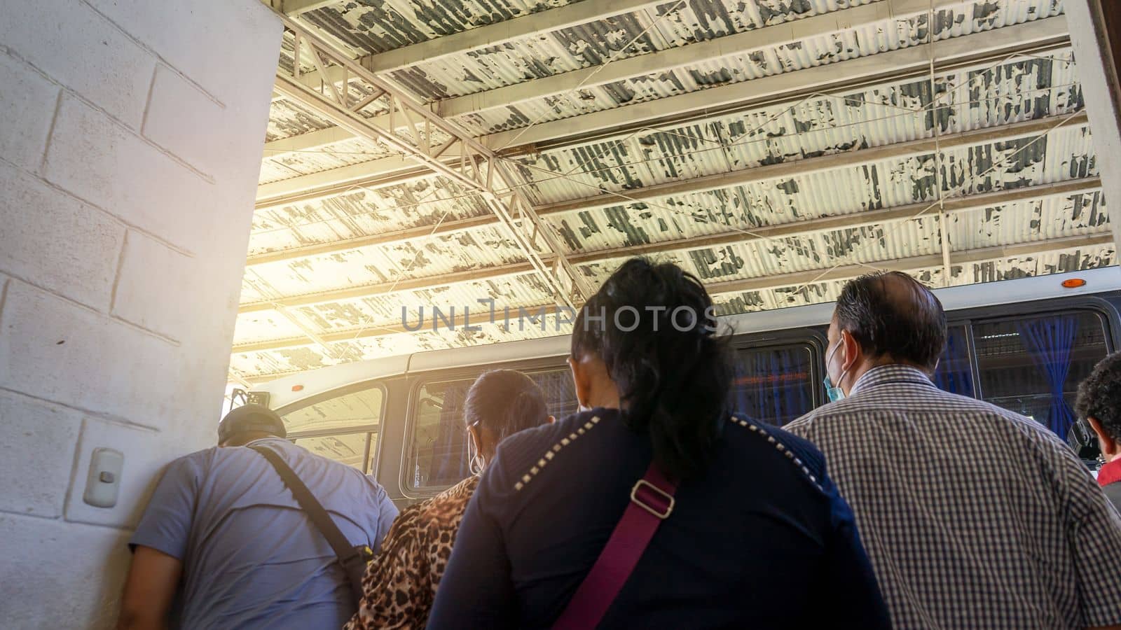Latin American people waiting for the departure of a bus in a terrestrial terminal