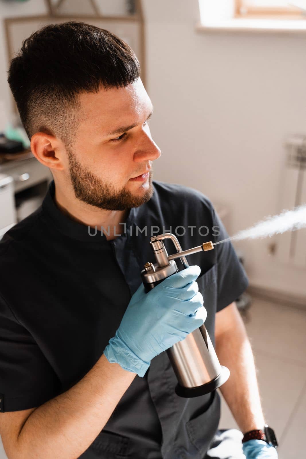 ENT doctor spray nitrogen for cryo therapy. Procedures of for mucosal renewal and treatment of chronic pharyngitis and tonsollitae. Doctor otolaryngologist with cryosprayer