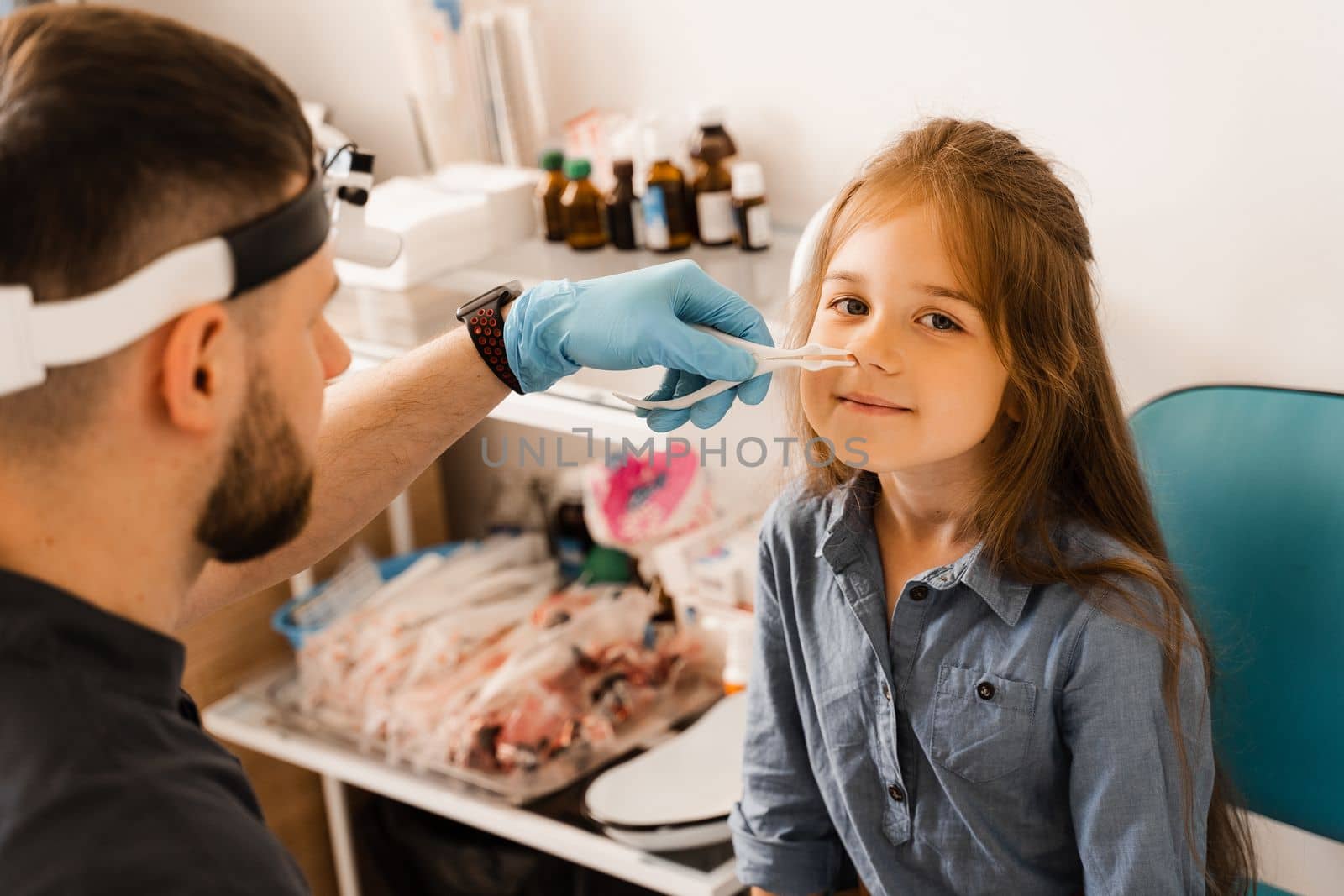 Rhinoscopy of child nose. Consultation with doctor. Children otolaryngologist examines child nose before procedure of endoscopy of nose. by Rabizo