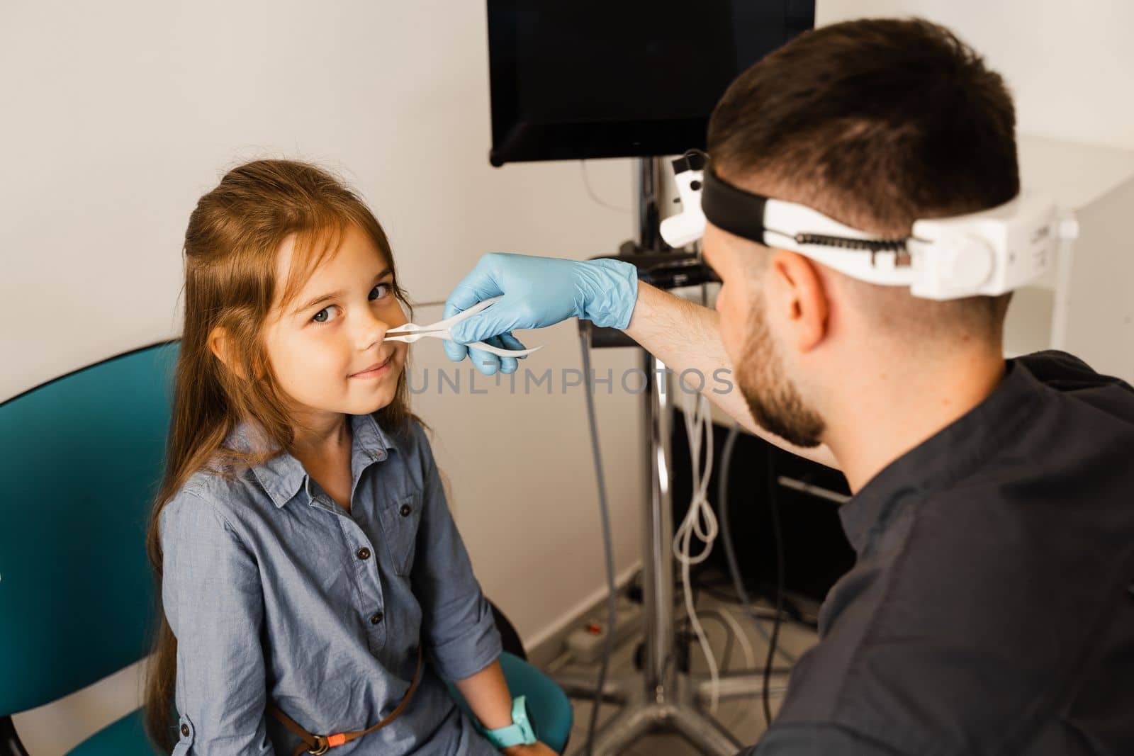 Rhinoscopy of child nose. Consultation with doctor. Children otolaryngologist examines child nose before procedure of endoscopy of nose