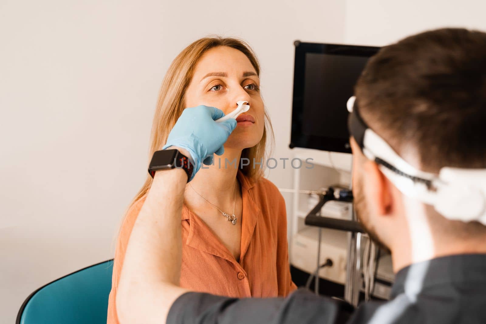 Rhinoscopy of woman nose. Consultation with doctor. Otolaryngologist examines girl nose before procedure of endoscopy of nose