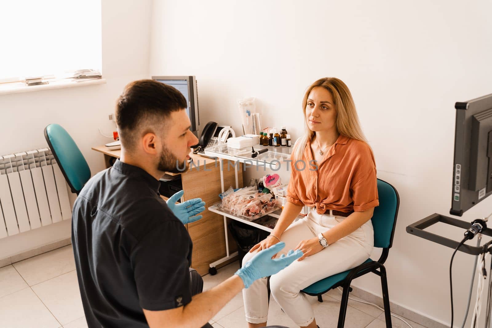 Visiting ENT doctor for examination of the state of health of the ear, throat and nose. Consultation of woman with otolaryngologist in a medical clinic