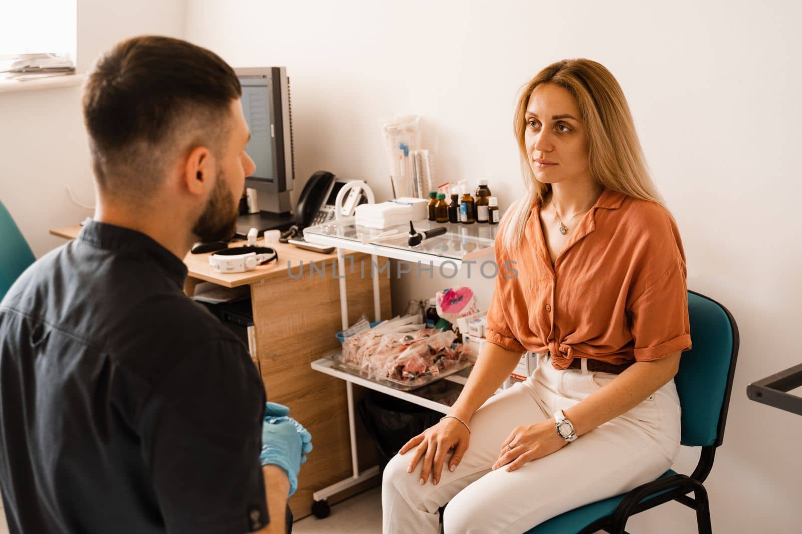 Visiting ENT doctor for examination of the state of health of the ear, throat and nose. Consultation of woman with otolaryngologist in a medical clinic