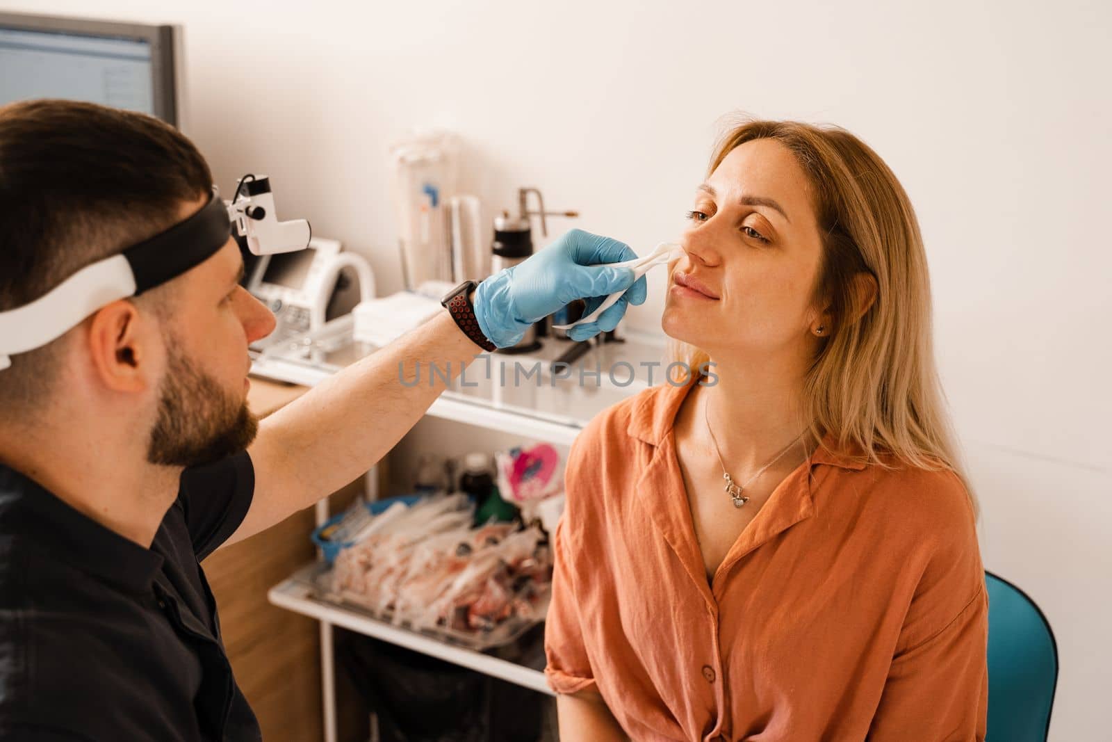 Rhinoscopy of woman nose. Consultation with doctor. Otolaryngologist examines girl nose before procedure of endoscopy of nose. by Rabizo