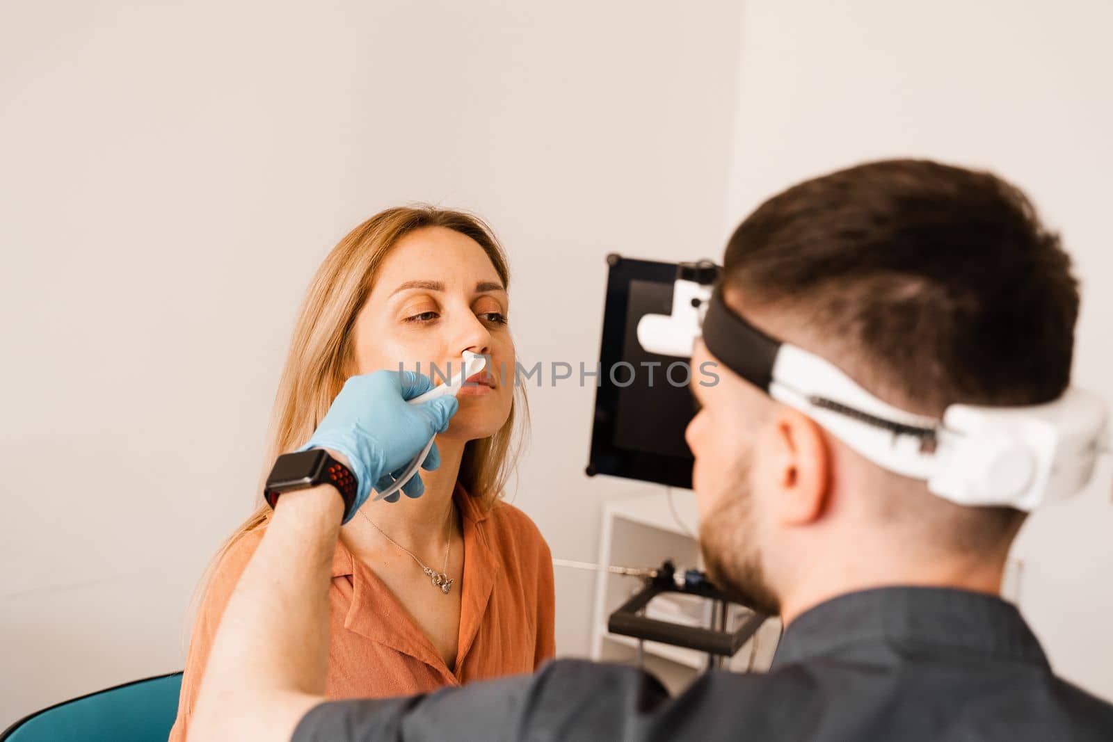 Rhinoscopy of woman nose. Consultation with doctor. Otolaryngologist examines girl nose before procedure of endoscopy of nose