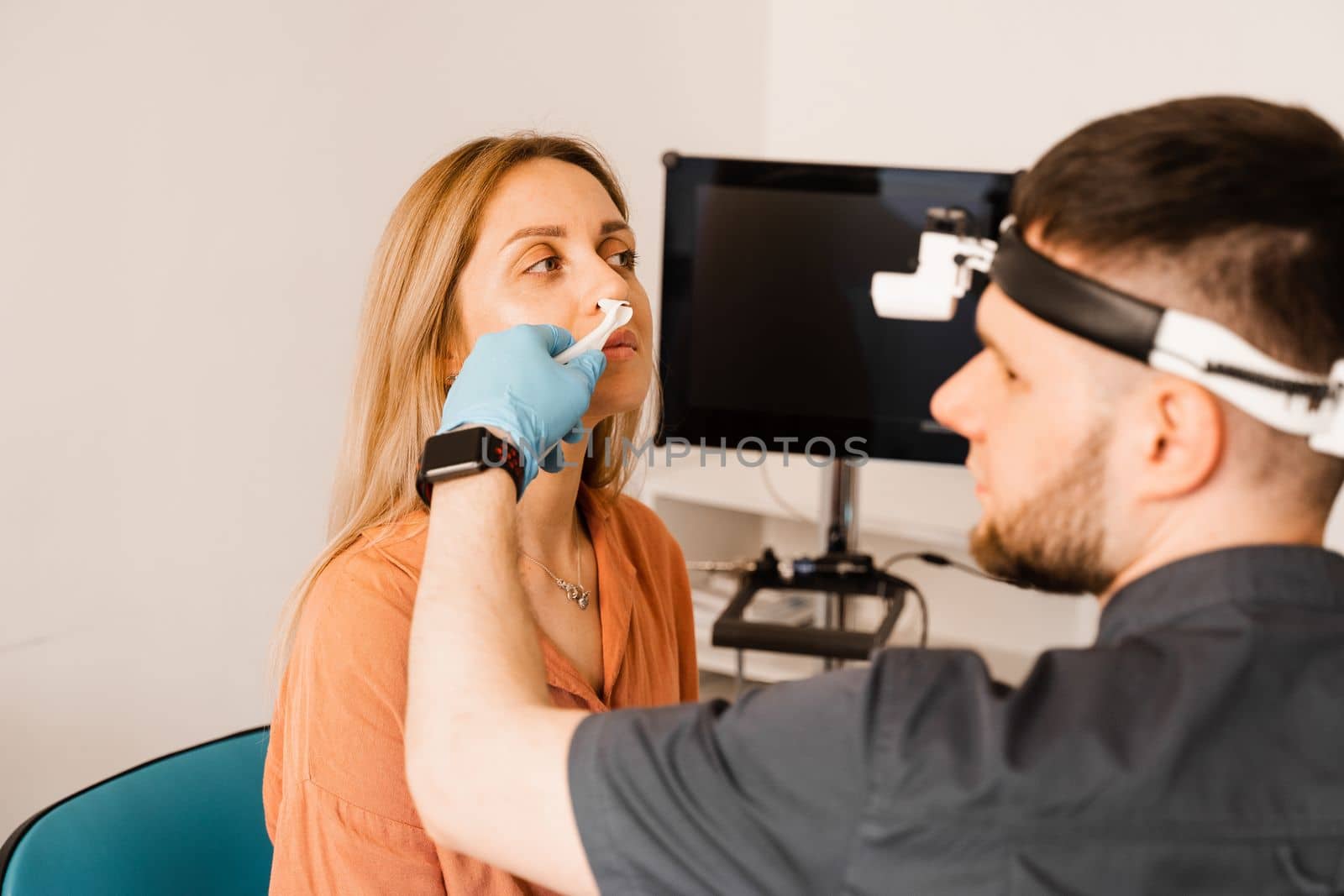 Rhinoscopy of woman nose. Consultation with doctor. Otolaryngologist examines girl nose before procedure of endoscopy of nose