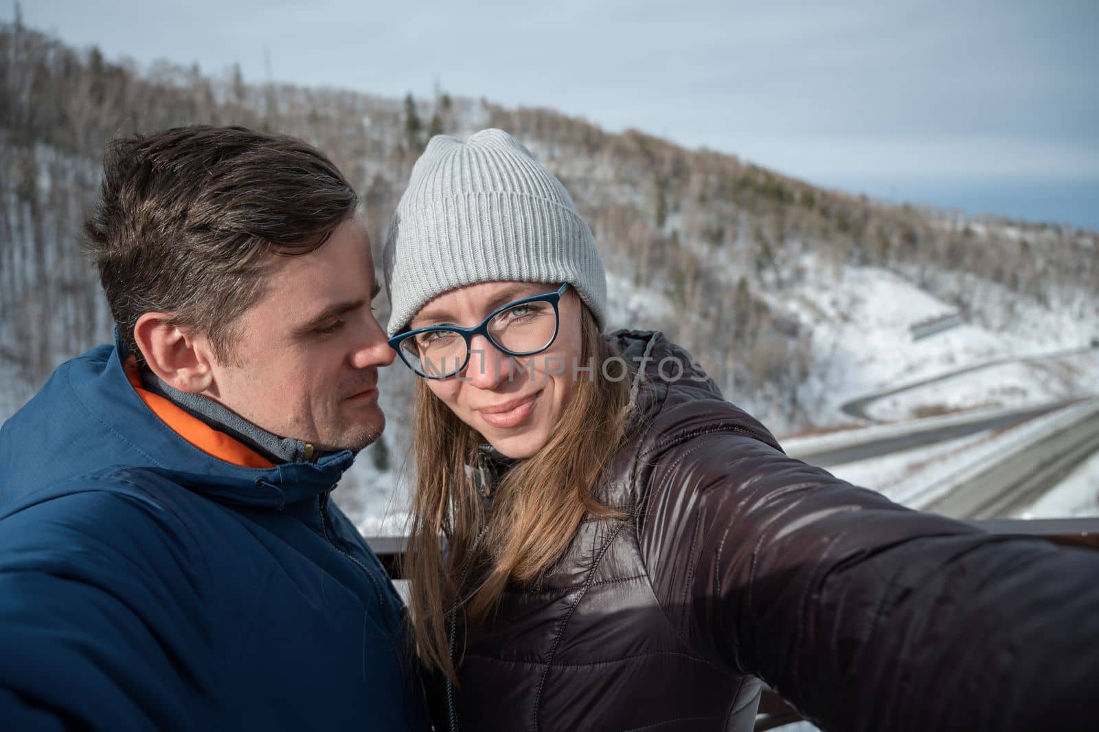 Happy family with walking in snowy winter forest, selfie photo