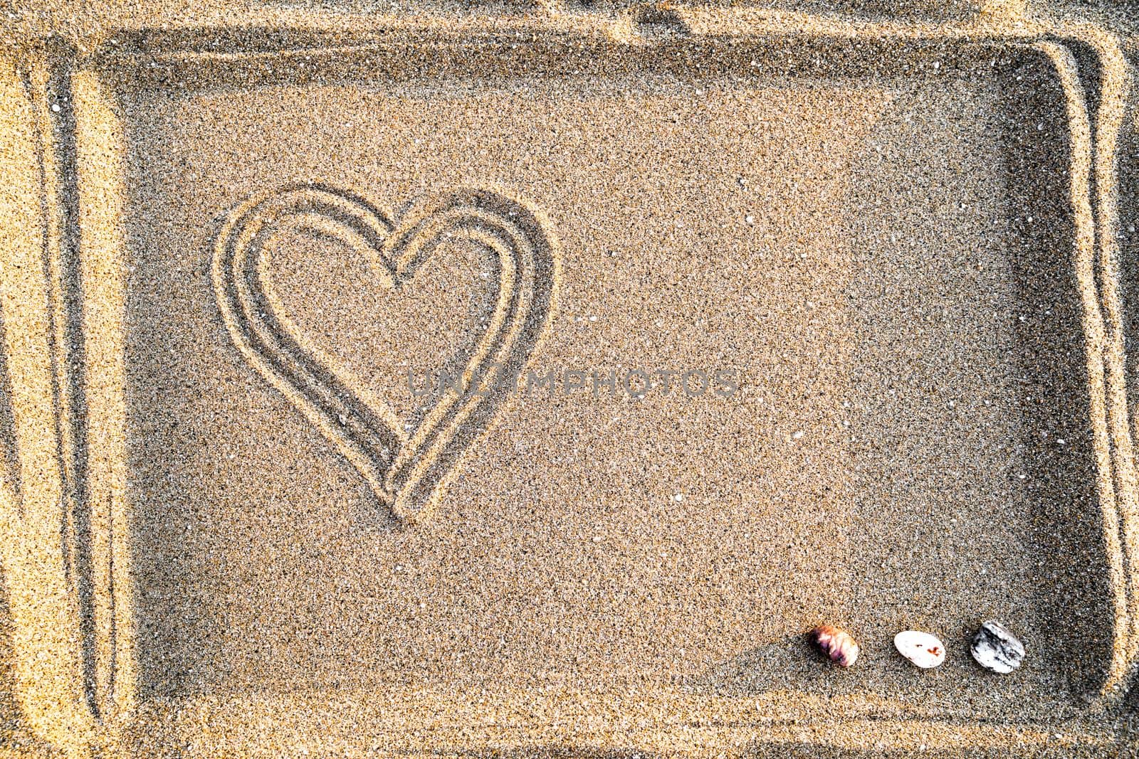 Drawing of heart in sand, concept of love and health, top view, copy space