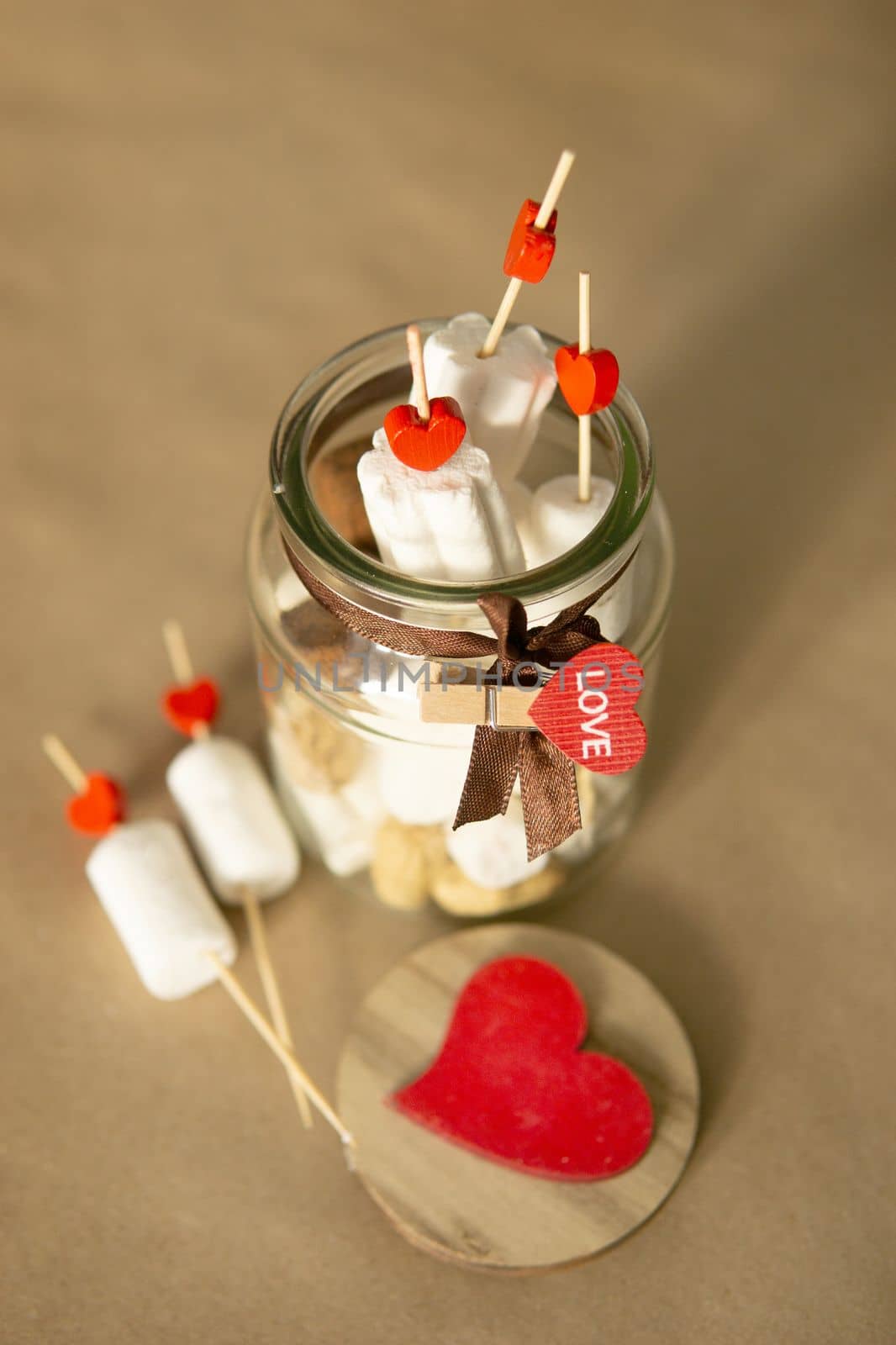 sweet gift for Valentine's Day with your own hands. A gift for the holiday made of heart-shaped candies and marshmallows.