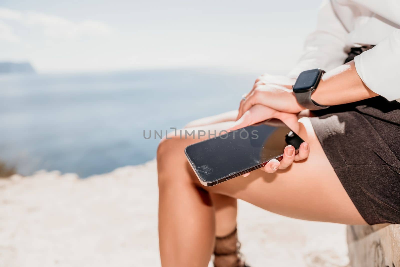 Woman sea laptop. Business woman in yellow hat freelancer with laptop working over blue sea beach. Girl relieves stress from work. Freelance, digital nomad, travel and holidays concept by panophotograph