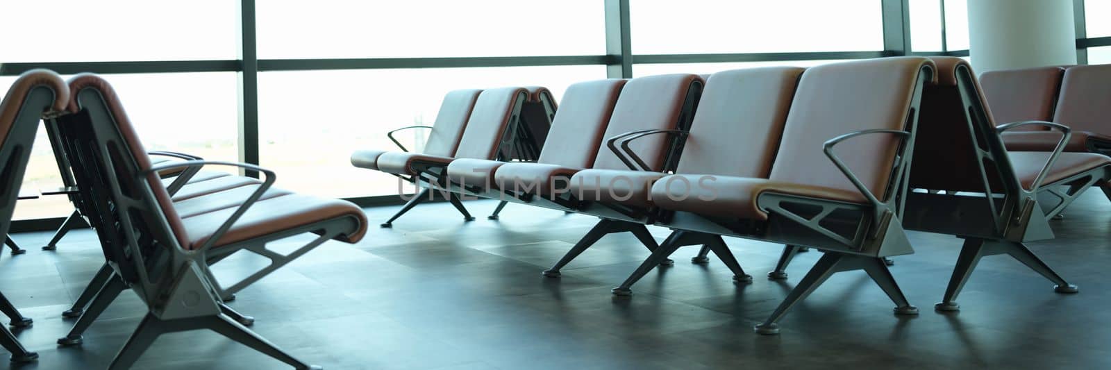 Empty departure hall at airport or international train station. Stylish interior and leather seats at airport concept